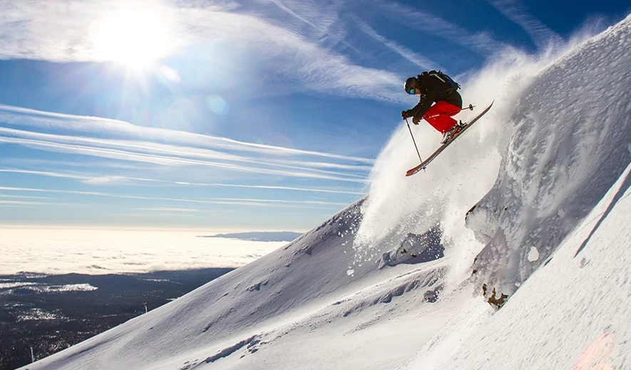 Skier dropping in off the cornice on the Summit of Mt. Bachelor