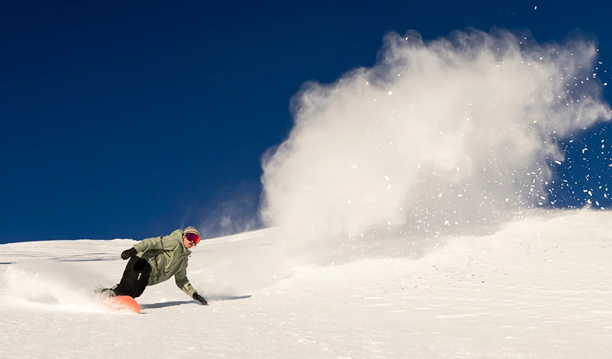 Snowboarder on a bluebird day at Mt. Bachelor